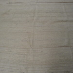 A light tan flatweave rug with horizontal dashed lines and subtle natural color variation.