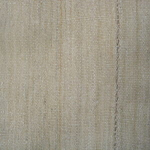 Beige woven rug with a tight texture and stitched vertical line resting on wood planks.