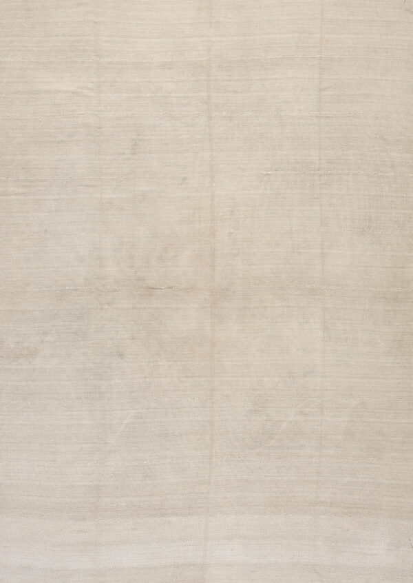 Monochromatic light tan rug featuring a visible horizontal ribbed texture across the surface.