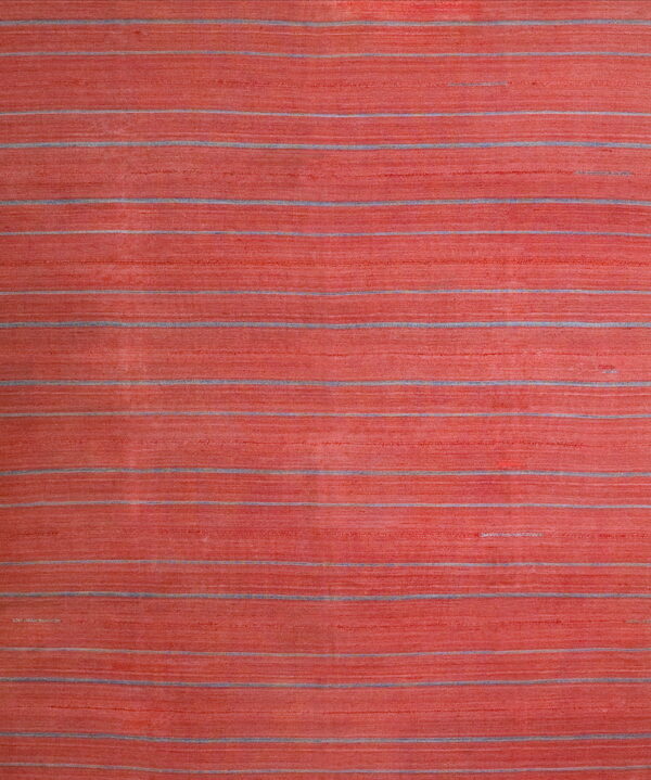 Textured coral rug with thin horizontal stripes of gray and muted blue running across the surface.