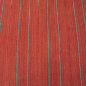 Red flat-weave rug featuring wide orange sections divided by narrow gray vertical stripes.