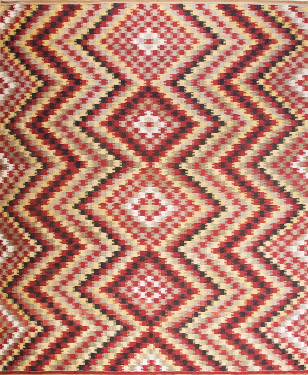 Red, black, gold, and gray flatweave rug with a repeating geometric serrated diamond pattern.