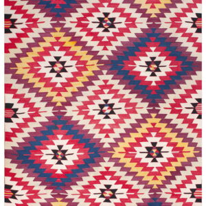 Flatwoven rug in bold red, blue, purple, and yellow stepped geometric designs on a cream field.