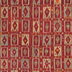 Flatweave rug with a repeating geometric grid pattern of red, gray, blue, and tan diamond motifs.