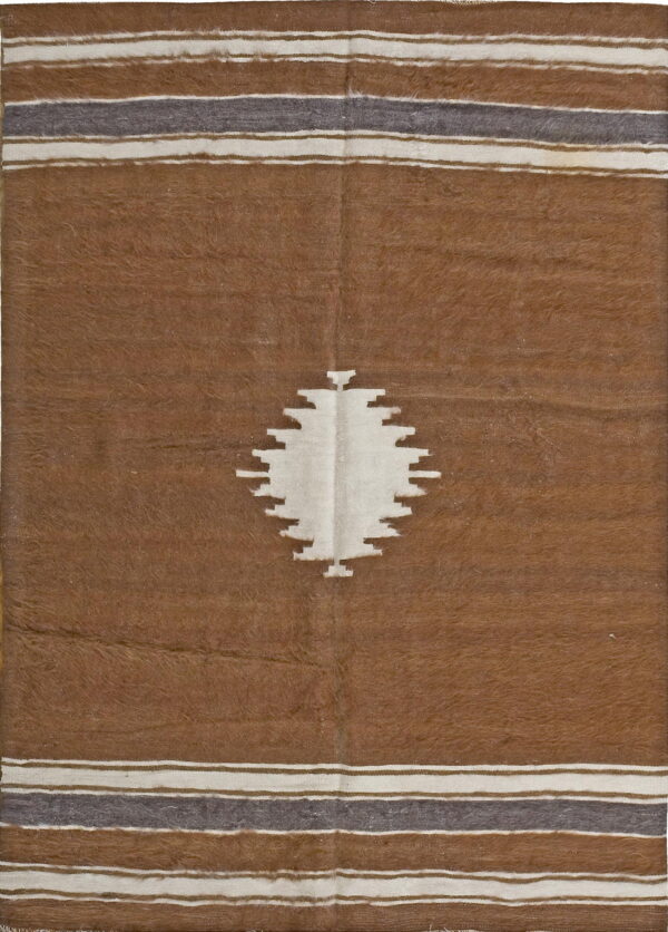 Brown shaggy rug with a white stepped center motif and horizontal gray and cream borders.