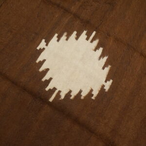 Brown, shaggy rug with a cream serrated geometric pattern and striped border along one edge.
