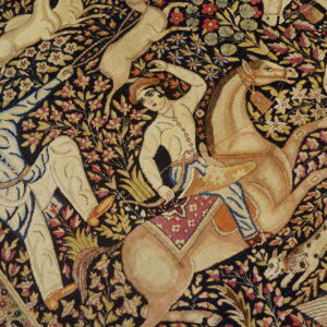 Detailed pictorial rug with a navy background, showing tan riders, horses, and various animals among colorful flowers.