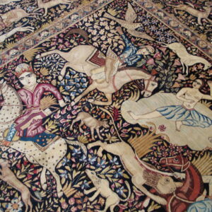 Detail of a densely patterned rug with dark ground, showing colorful figures, horses, and animals among floral vines.
