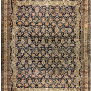 Traditional area rug with a dark blue repeating pattern field and detailed multi-layered cream borders.