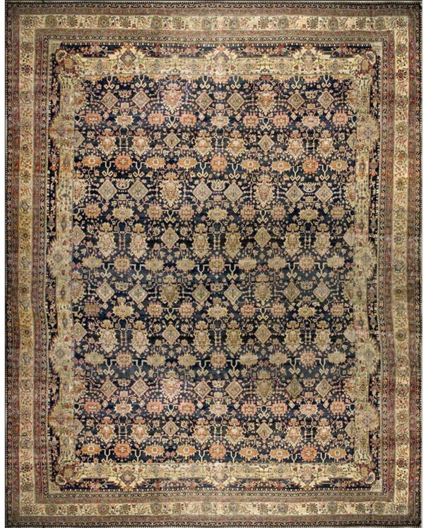 Traditional area rug with a dark blue repeating pattern field and detailed multi-layered cream borders.