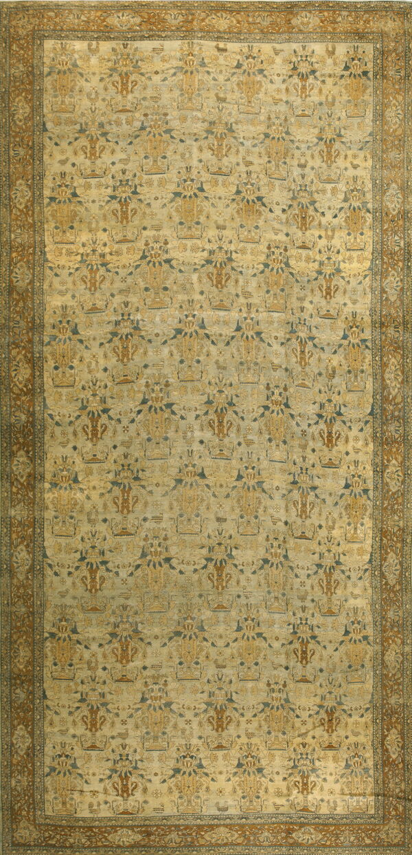 Low-pile rug with a repeating gold, brown, and teal urn pattern on a faded cream field and amber border.