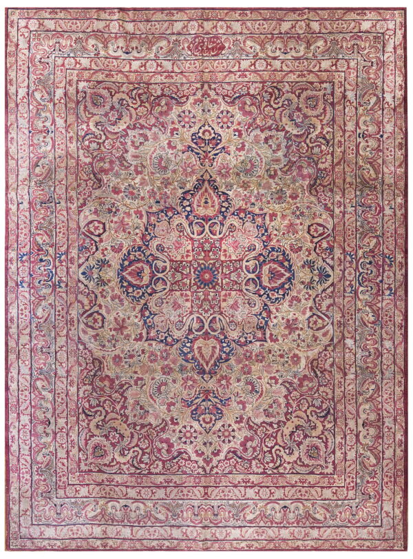Ornate area rug in faded red, cream, and dark blue with complex floral borders and a central medallion.