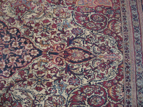 Traditional rug pattern in deep burgundy, navy, and cream featuring intricate florals and a vertical border.