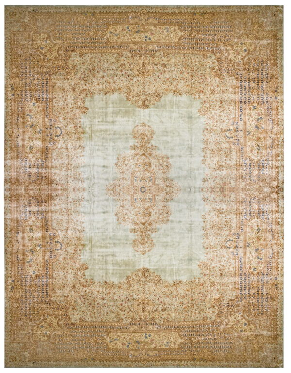 Low-pile rug featuring a pale green distressed center and detailed tan floral motifs around the border.