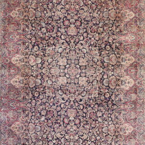 Densely woven traditional rug featuring an all-over floral and vine pattern on a dark navy and rose background.