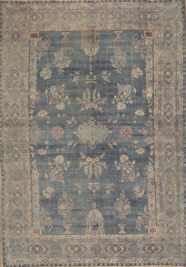 Muted blue low-pile rug with intricate beige, blush, and slate traditional floral and paisley designs.