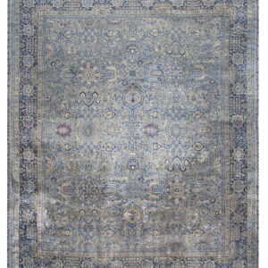 Dusty blue traditional rug with navy and cream accents, featuring a faded all-over floral pattern.