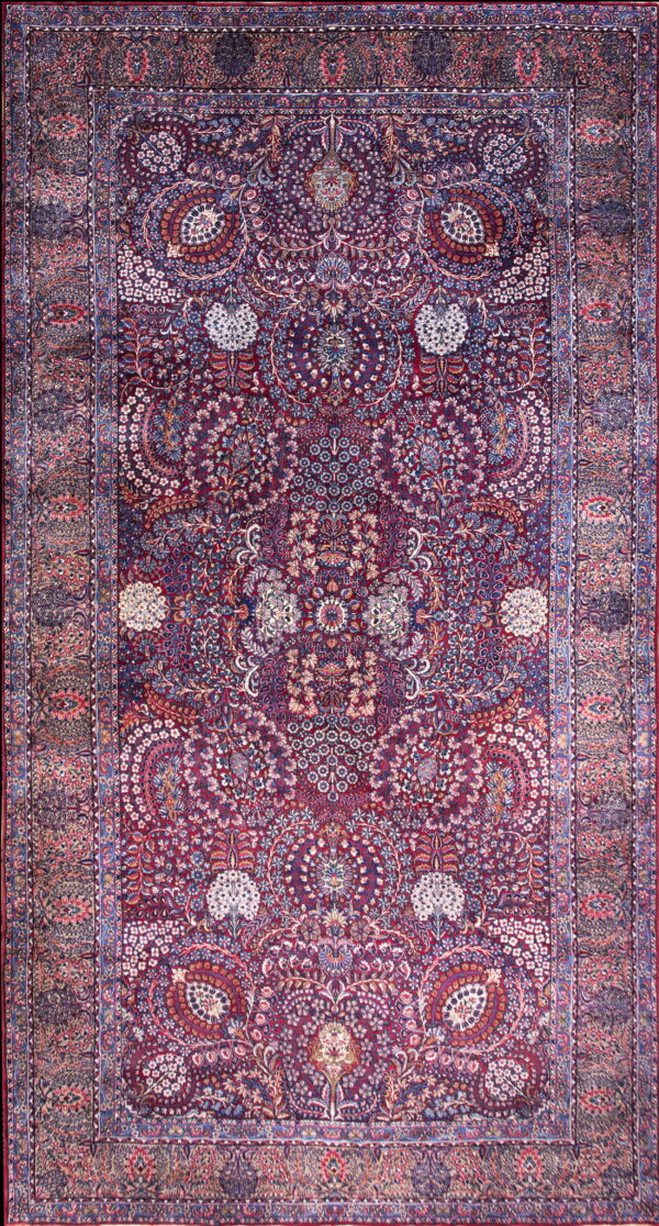 Traditional burgundy rug featuring a complex design of botanical motifs in navy blue, white, and red.