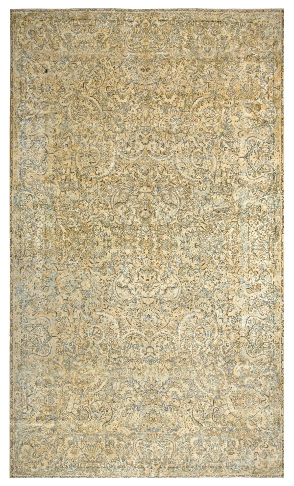 Faded traditional rug with a dense botanical pattern in cream, tan, brown, and muted blue.