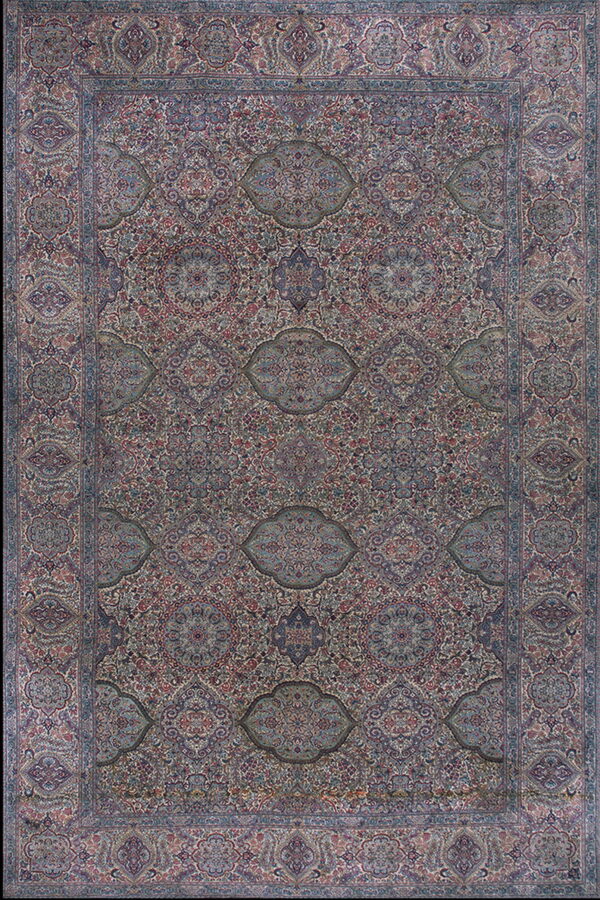 Intricate traditional rug with dense repeating medallions and floral patterns in blue, red, and cream.