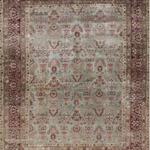 Ornate traditional rug with a light teal field featuring red botanical patterns and wide burgundy floral borders.