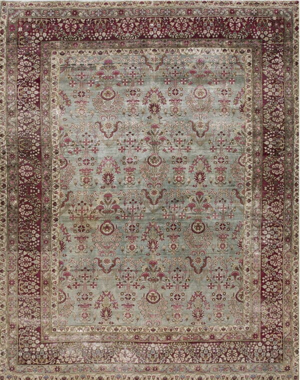 Ornate traditional rug with a light teal field featuring red botanical patterns and wide burgundy floral borders.