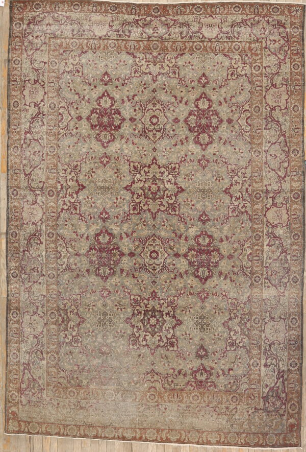 Traditional low-pile rug featuring intricate burgundy and faded taupe floral patterns on wood flooring.
