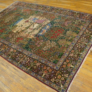 Multicolored Tree of Life area rug with a detailed central figural scene, displayed on rustic light wood flooring.