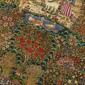 Green rug featuring a detailed pictorial pattern of red and white flowers, lush trees, water, and birds.