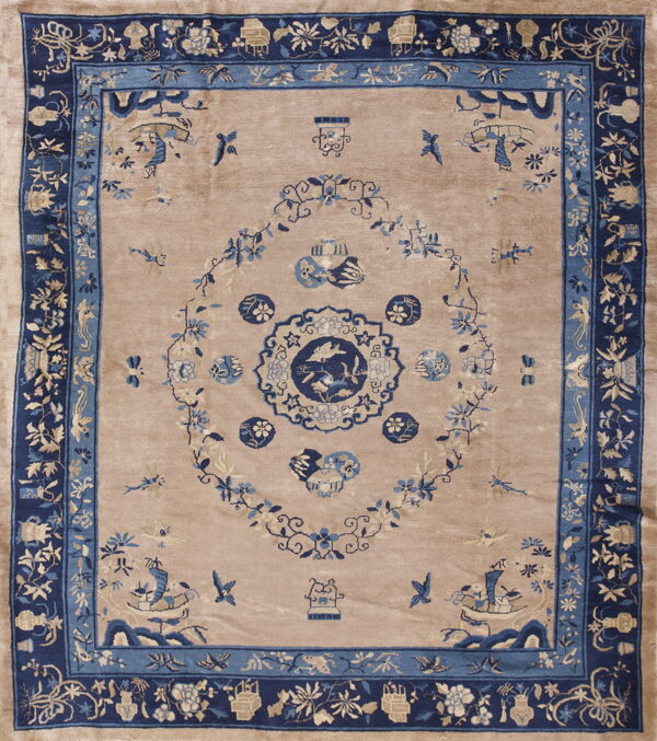 Beige rug with dark blue borders and light blue floral and pictorial motifs.