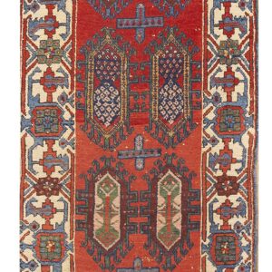 Geometric red runner rug with repeating central tribal motifs and multicolored, detailed cream borders.