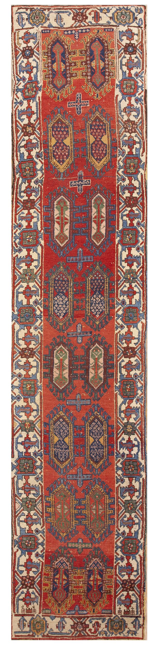 Geometric red runner rug with repeating central tribal motifs and multicolored, detailed cream borders.