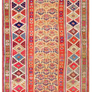 Multicolored flatweave runner featuring a tan central panel of floral designs and bold red geometric borders.
