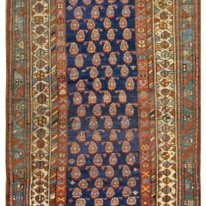 Dark blue runner rug with alternating rows of teardrop motifs and complex geometric borders in red and ivory.