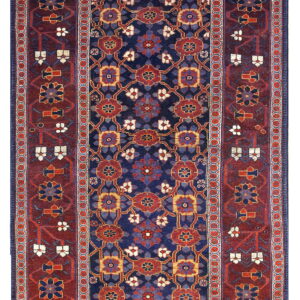 Deep blue runner rug with a repeating geometric pattern and a wide burgundy border featuring stylized flowers.