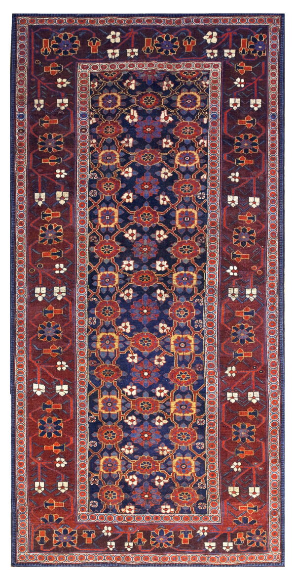 Deep blue runner rug with a repeating geometric pattern and a wide burgundy border featuring stylized flowers.