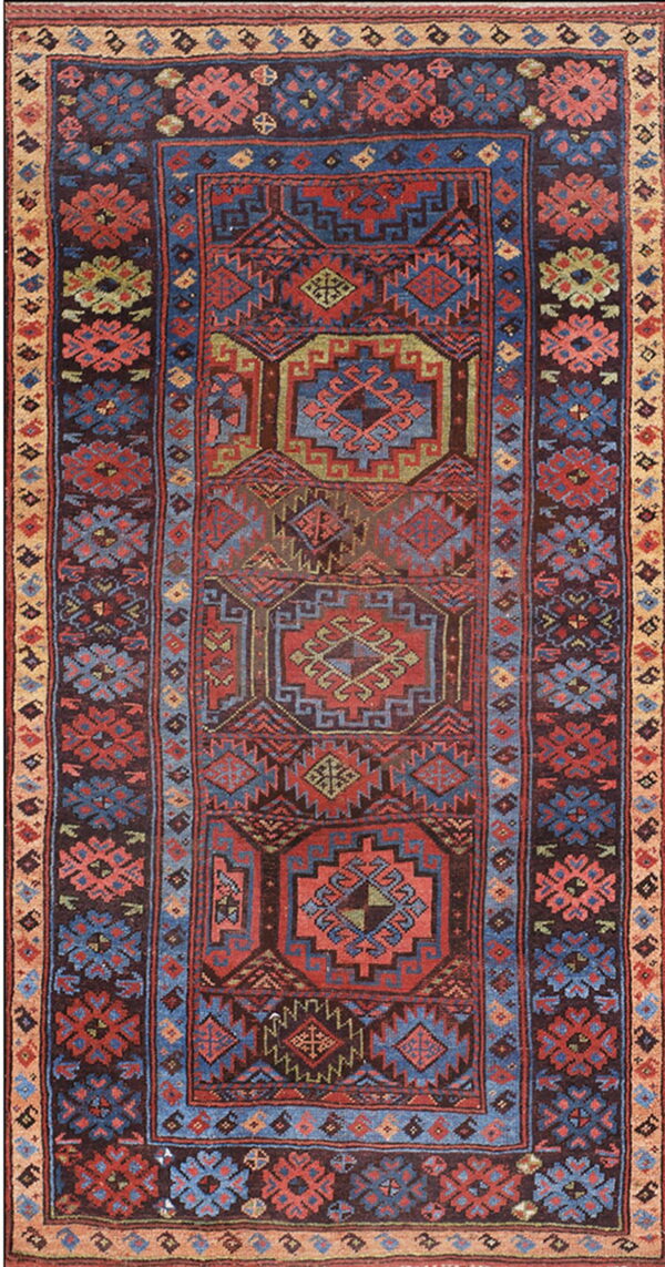 Low pile rug in deep red, blue, and brown with complex geometric and stylized floral patterns.