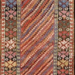 Runner rug with a central diagonal stripe pattern bordered by traditional geometric motifs in red, blue, and black.