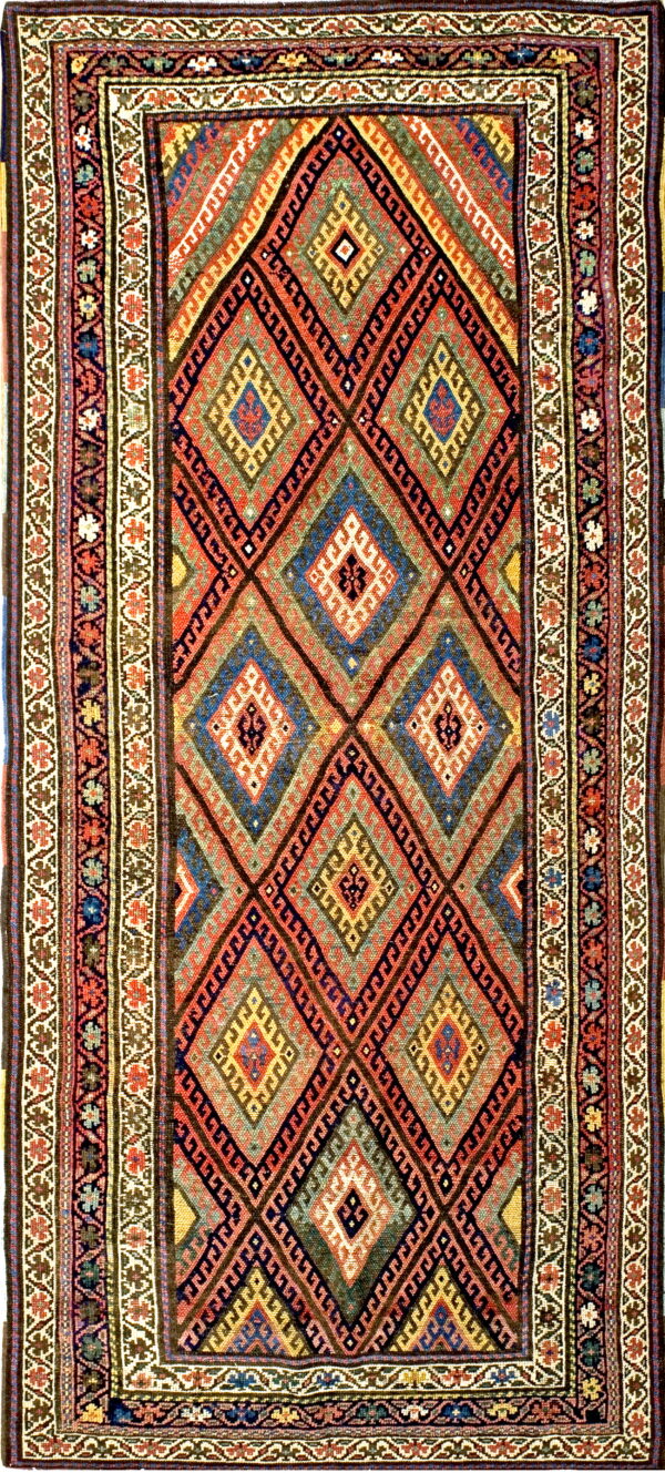 Colorful geometric rug with a field of large, interlocking diamonds and detailed multicolored borders.