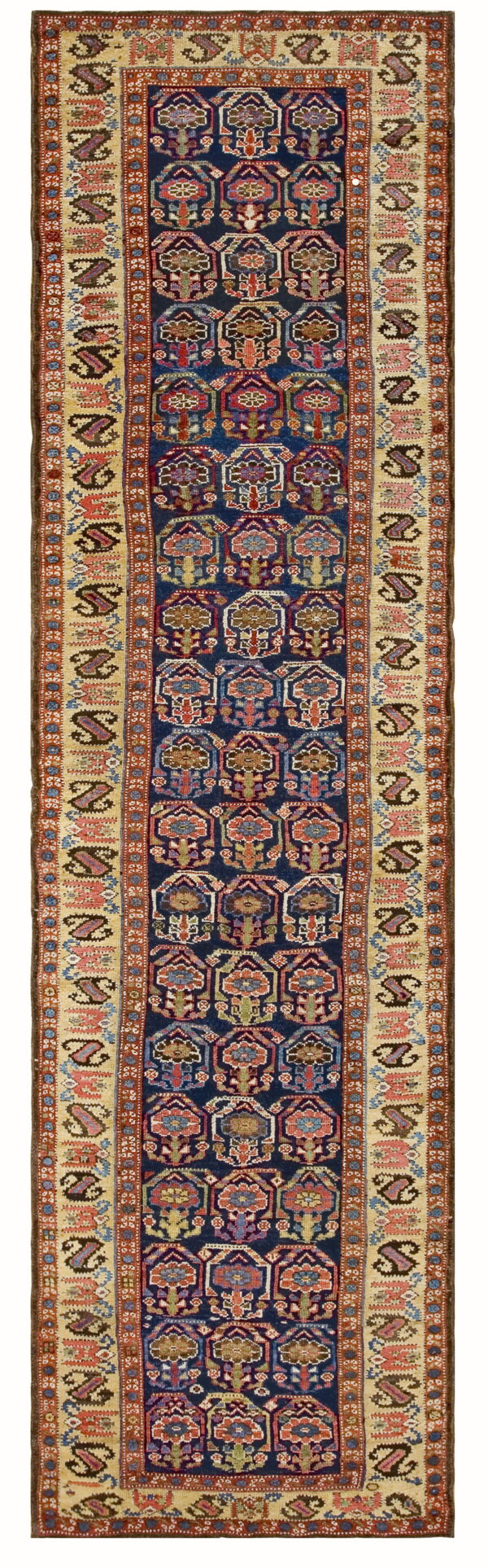 Geometric navy blue runner rug with repeating gabled motifs and a wide cream and red border.