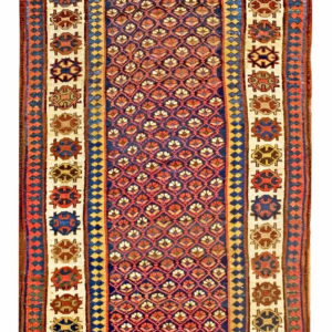 Red, blue, and cream runner rug with a repeating diamond pattern surrounded by octagonal medallions.