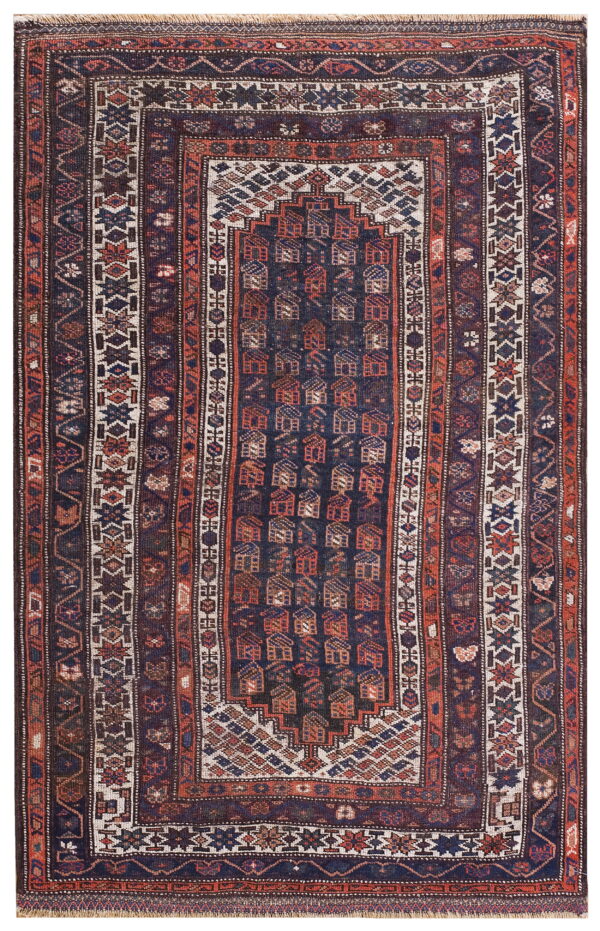 This dark blue and terracotta geometric rug has a central panel of repeating stylized house motifs.