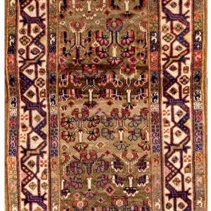 Long runner rug with an olive green ground, stylized tribal pattern, and bold geometric borders.