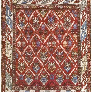 Low pile rug featuring a red field, geometric diamond lattice, and stylized multi-colored plant motifs.
