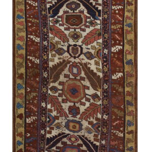 Narrow runner rug with a cream field, vertical tribal medallions, and wide borders in rust and gold.