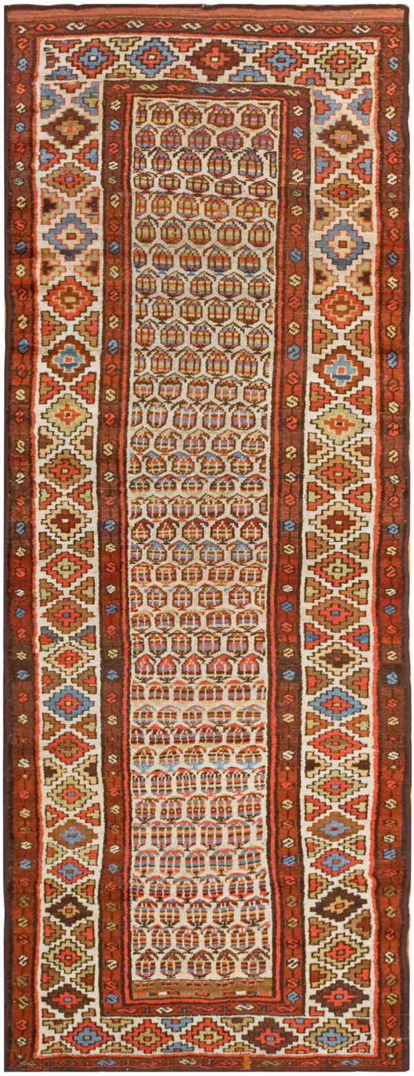 Geometric runner rug featuring stacked diamonds and repeating arched shapes in cream, rust, blue, and tan.