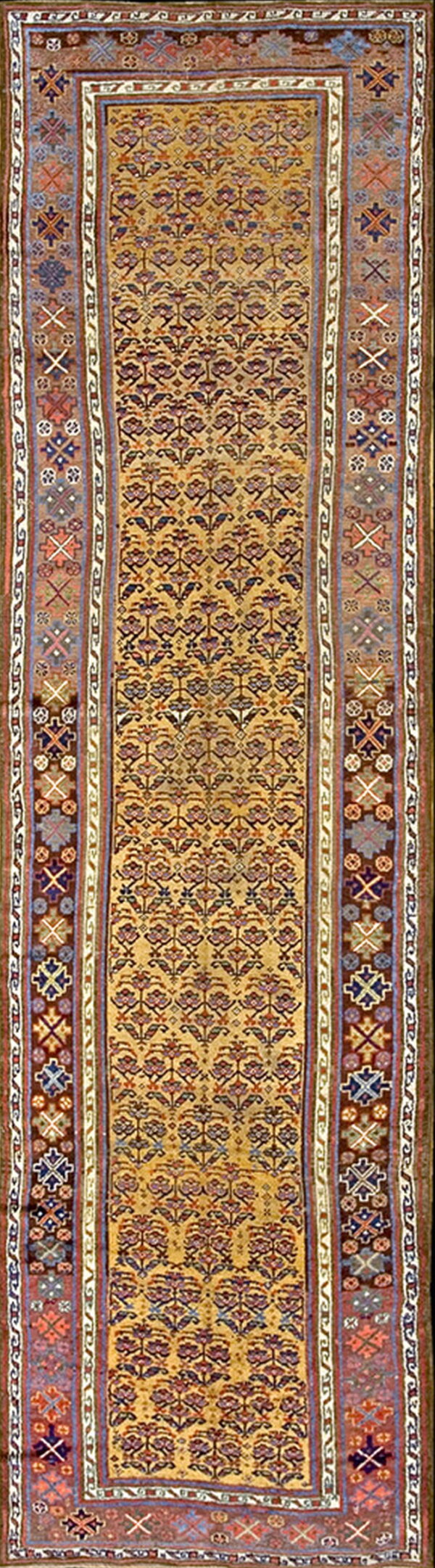 Gold runner rug displaying small repeating purple and red floral designs framed by complex geometric side borders.