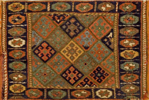 Coarse, low-pile rug featuring complex diamond and medallion patterns in olive green, navy, and deep orange.