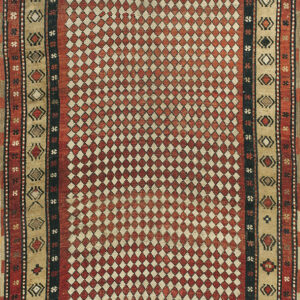 Red and beige rug featuring an all-over small diamond pattern and multi-layered geometric borders.