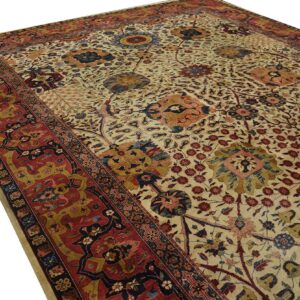 Detailed traditional rug featuring a colorful floral, vine, and stylized animal pattern on a light cream field.